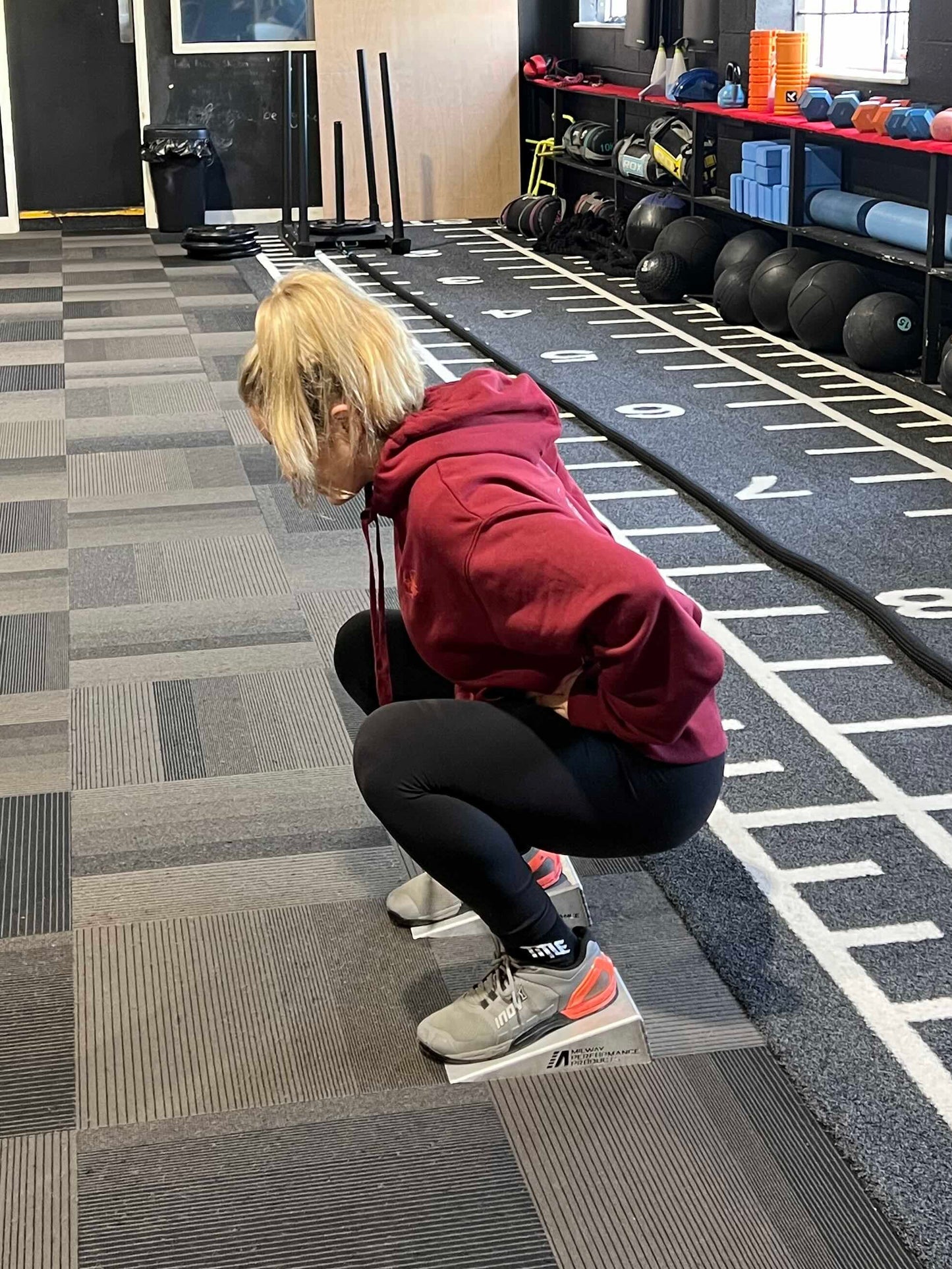 Slant boards for squatting to increase depth 