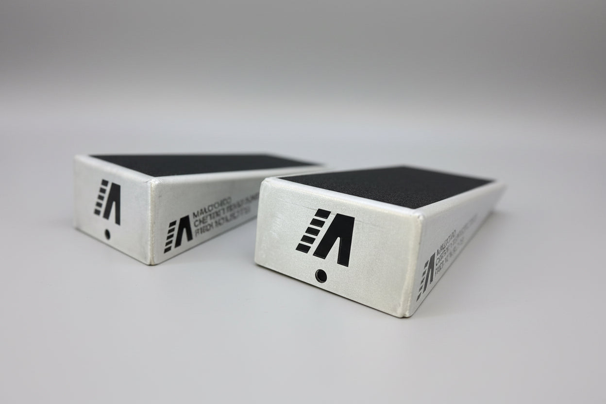 a pair of silver slant boards with black grip tape rehab tools physio heel lifts squat wedges