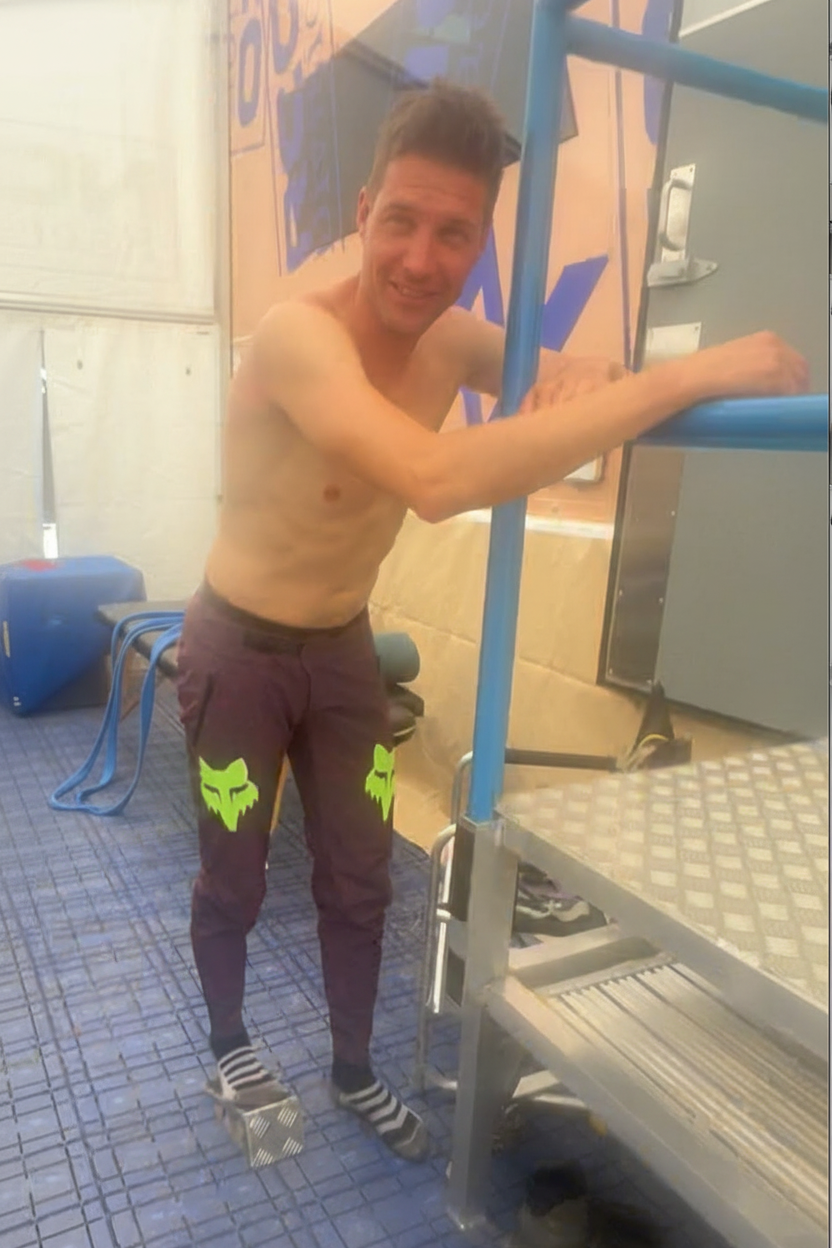 Man called Greg Minnaar using Milway Performance Slant Board to improve his ankle range during warm up for racing