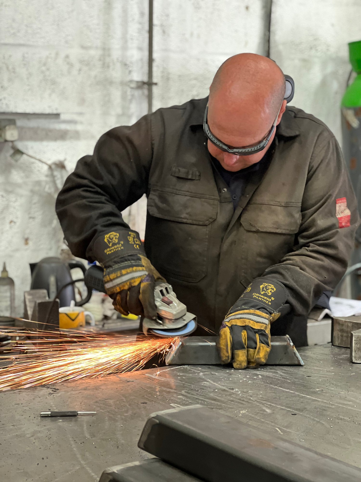 sparks flying as metal prepared for weights bench bench press in factory UK